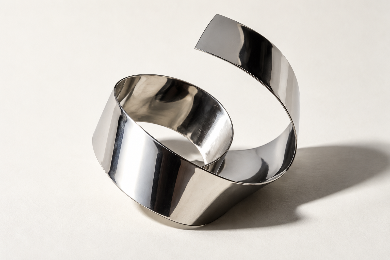 A folded chrome ribbon with light and shadow