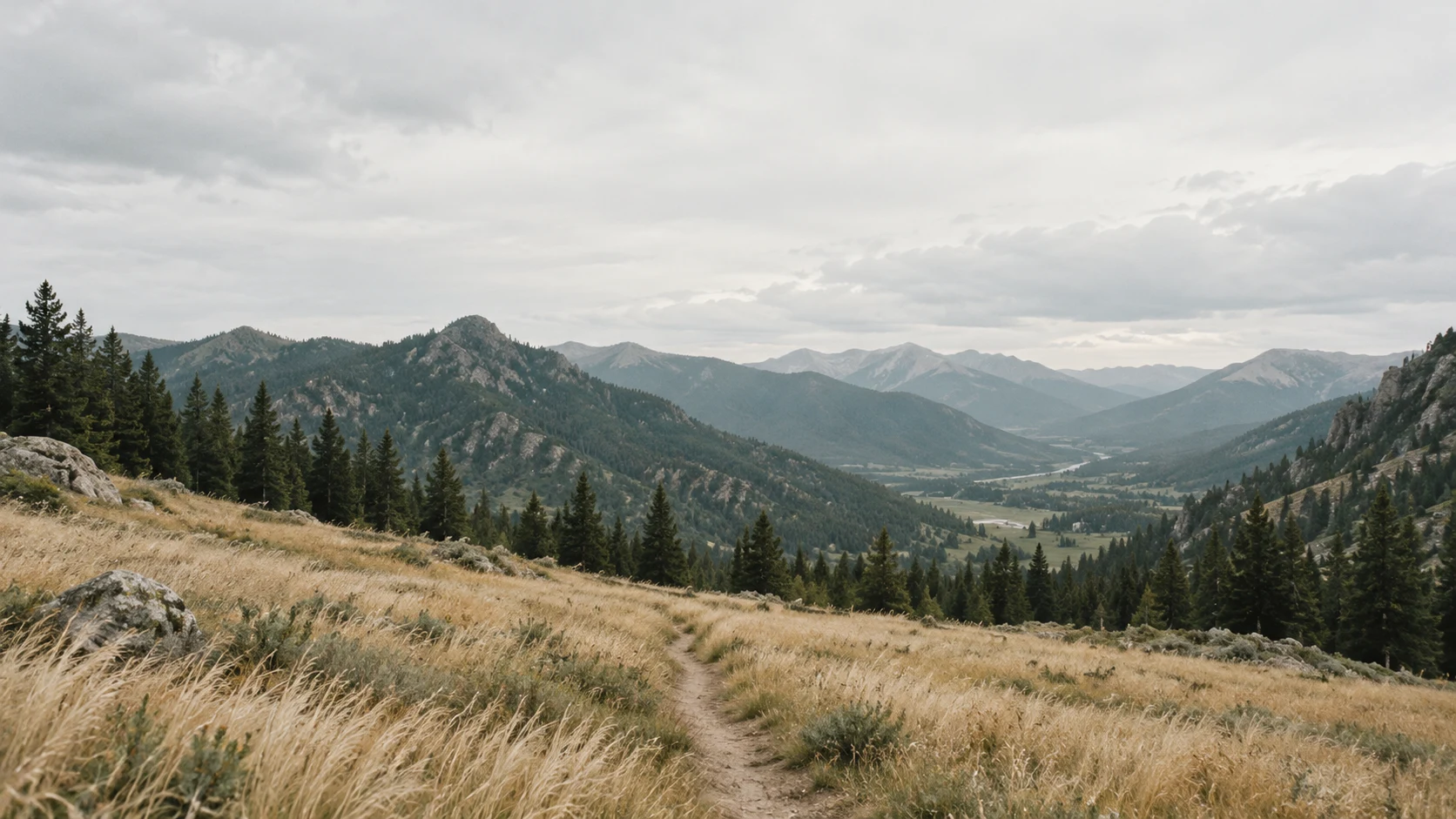 An imagined valley, grass and distant mountain ridges